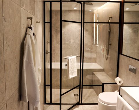 hotel spa-like bathroom with Pivotech shower screen